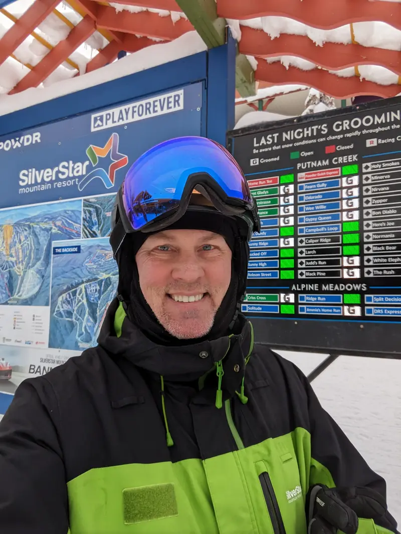 Sean Phillips in his SilverStar Mountain Host jacket at the village grooming board